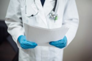 A medical provider reads from a patient's medical records