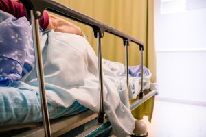 An incorrect or delayed diagnosis patient lays in a bed in a hospital hallway