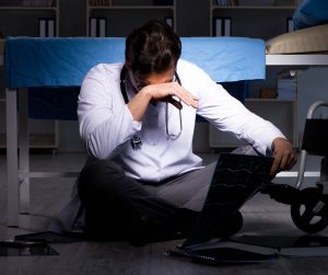A doctor looks upset after he has committed medical negligence.