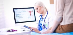 A doctor looking at an informed consent document before proceeding with the treatment plan