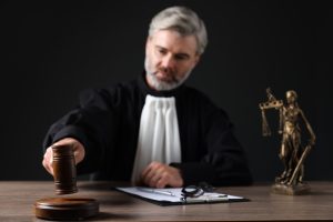 A gall bladder surgery negligence solicitor with a gavel at a desk. 