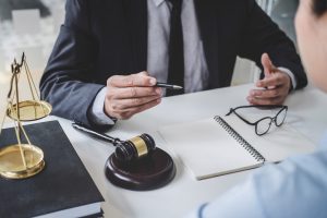 A client in a blue shirt asking their solicitor "how long does a medical negligence claim take to settle?"