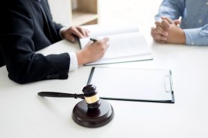A medical negligence solicitor discussing financial compensation with his client during a meeting