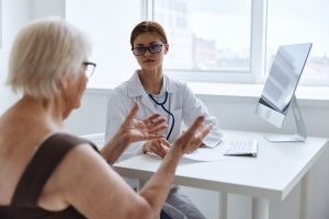 An old lady discussing the possibility of nursing home negligence claims with the manager.
