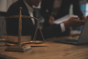 A solicitor sat at their desk with justice scales discusses medical negligence in private hospitals